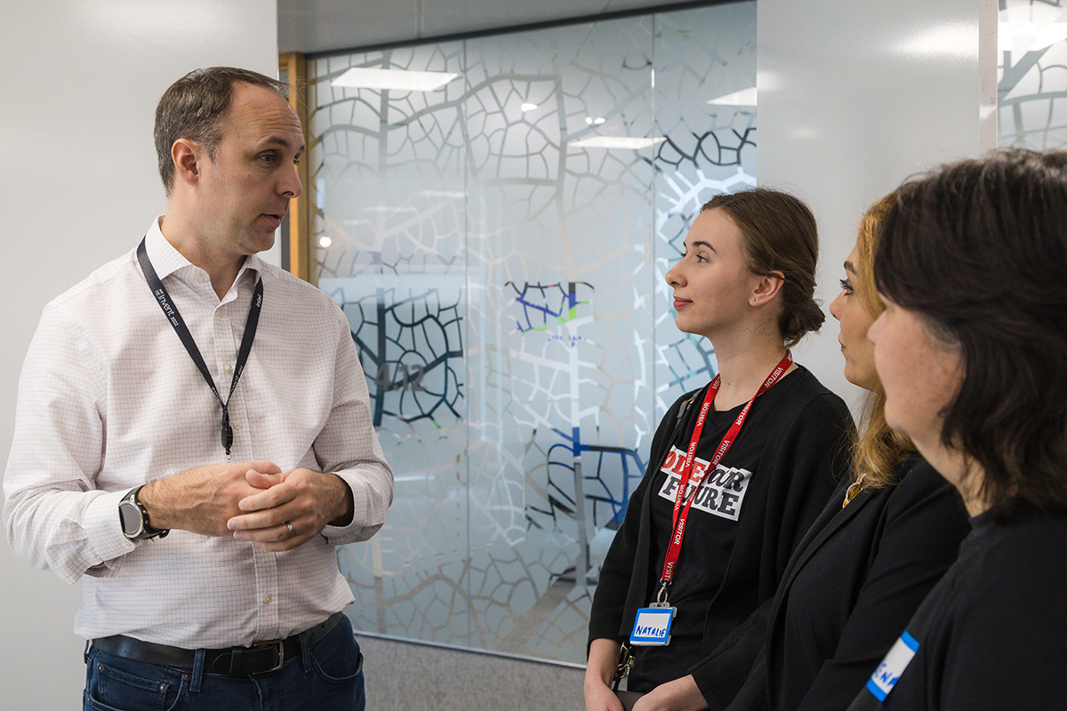 Photo of Natalie and other trainees meeting someone. 