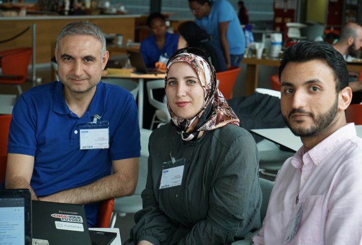 Trainees learning to code together in class
